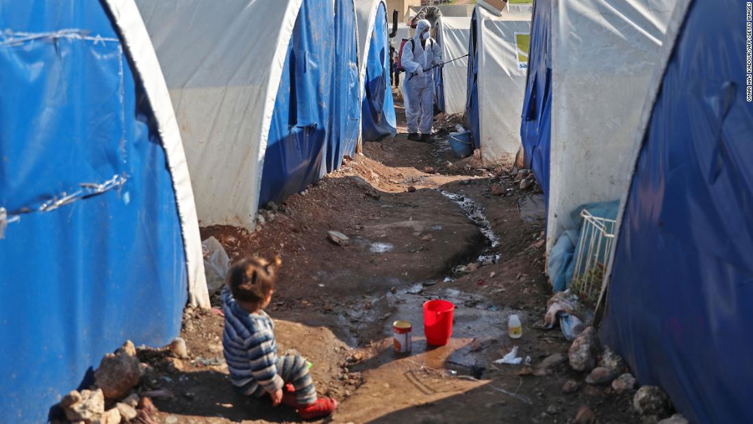 A member of the Syrian Violet relief group disinfects tents at a camp for displaced people in Kafr Jalis, Syria, on March 21.